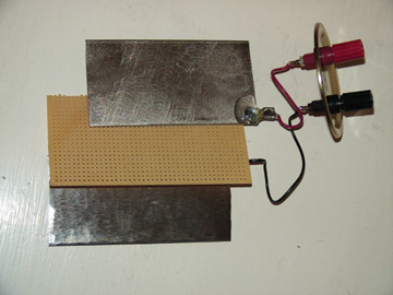 Experimental cell using a simple nickel and iron plate, each approximately 2” X 4”